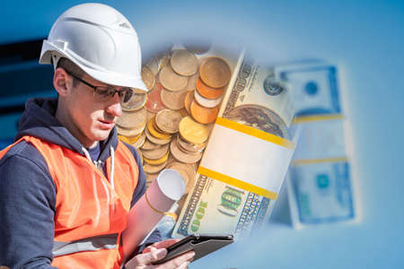 Foreman considers the costs. Builder considers cost of unexpected purchases. Architect with a tablet and drawings. Money. Concept - reducing construction costs. Search for investors for constructionの写真素材