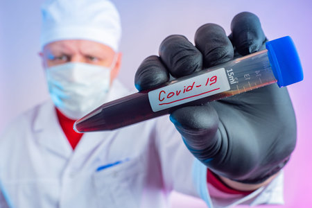 Test tubes with blood contaminated with covid 19. Blood is infected with a Chinese virus. Doctor...