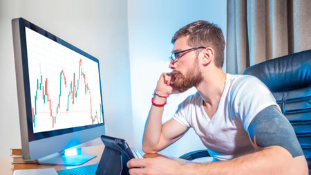 Financial analyst. Concept - a man works as a stock broker. Trader in his own office. Guy is looking...