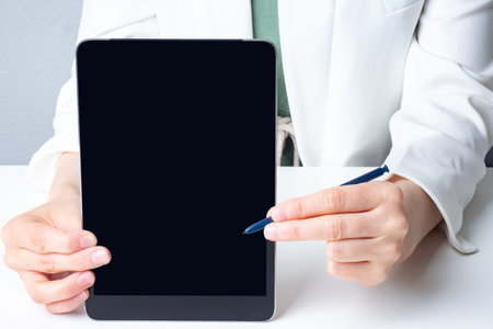 Close-up doctor tablet. Doctor holds a tablet while demonstrating screen. Medical application....