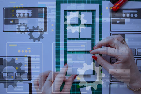 Mobile app development. Planning design made of paper. Man makes a prototype mobile application....