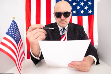 USA. Election president in United States. Male voter with billboard in his hands. Man in sunglasses on background of USA flag. election campaign in USA. US elections president. American voter voteの写真素材