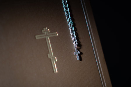 The Orthodox concept. The Orthodox cross is on the Bible. Faith and religion. faith in God. Faith in Jesus Christ. symbol of Christianity. Crucifixion. Miniature crucifix on a chain.の写真素材