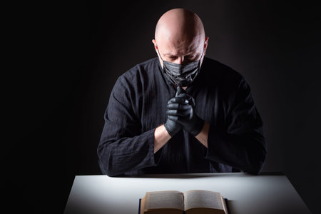 A religious man wearing a mask and rubber gloves. A person prays for health. A person sits, reads...