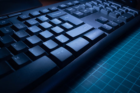 The keyboard lies diagonally on the desktop. Keyboard on the desktop close-up. Working on a PC. Computer accessories.の写真素材