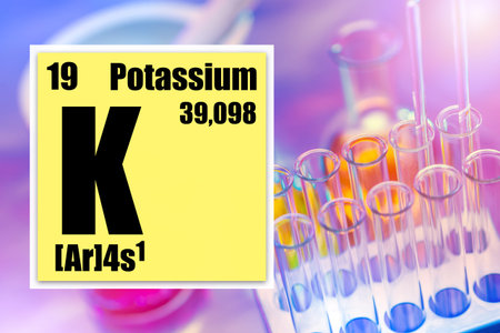Potassium. Potassium from the periodic table. A cell from the periodic table next to test tubes....