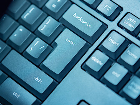 Buttons on a computer keyboard close-up. The black keyboard lies diagonally. The computer control keys are located on the keyboard. Technical background of black pc buttons.の写真素材
