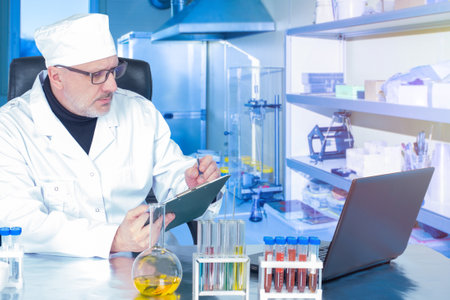 Laboratory Assistant. Virus sample on a laboratory bench. Doctor records the test results. Concept - laboratory for testing patients. Testing for verification of nucleation. Fever research.の写真素材