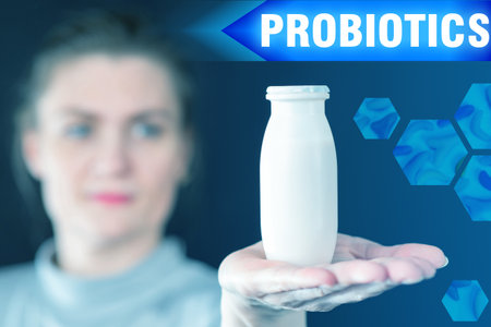 Treatment with probiotics. Girl shows a bottle with probiotics. Woman shows a biotic supplement. Treatment with live microorganisms. Beneficial bacteria treatment. Use of probiotics in healthcare.の写真素材