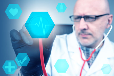 Doctor holds a stethoscope in his hands. Mudik checks a person heartbeat. Doctor applies a stethoscope to screen. Experienced doctor makes a diagnosis. Heart disease diagnosis. Heartbeat line.の写真素材