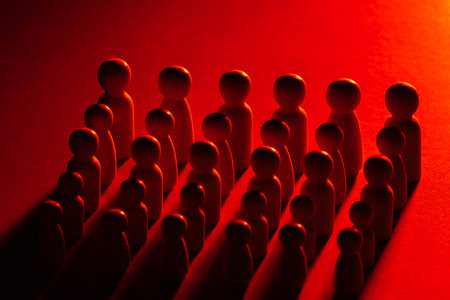 Concept of staff reduction. Red color symbolizes mass contractions. Optimization of personnel in business. Reducing number of company employees. Optimization of personnel to reduce costs.の写真素材