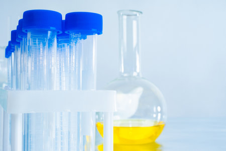 Empty test tubes on a medical table. Concept - lack of samples for study. Medical flask with a yellow liquid. Concept - the vaccine in large medetsinskoy flask. Virologist created a vaccineの写真素材