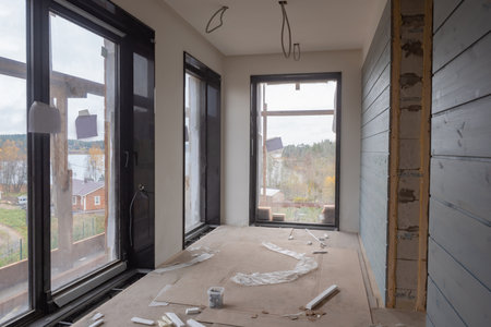Construction of a cottage with panoramic Windows. View from new room to the lake and cottage village. Construction work. Construction of private houses. Panoramic glazing.の写真素材