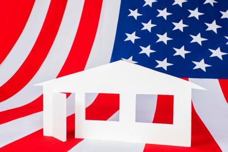 Real Estate in America. Layout of house on American flag. Concept - US real estate market. Investments in US real estate funds. Investing money in REIT. Investment in US REIT. Buying home in America.の写真素材