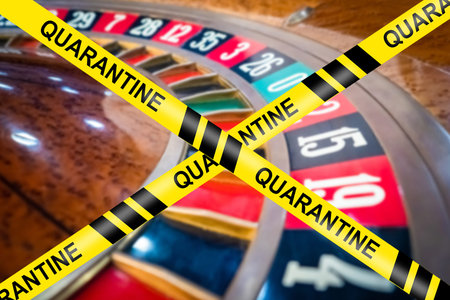Closing a quarantine casino. Tape quarantine on the background of the roulette table. Concept - the...
