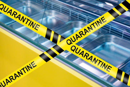Empty counters next to warning tape. Tape warns of quarantine closure. Concept - quarantine store closure. Storefront refrigerator is empty due to quarantine. Concept - epidemic shortage.の写真素材