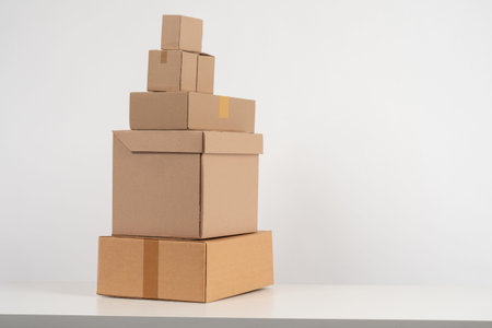 Cardboard boxes of different sizes on a white background. Packaging materials concept next to the...