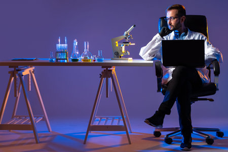 Man sits laboratory table. Laboratory testing performed on component. Laboratory testing components...