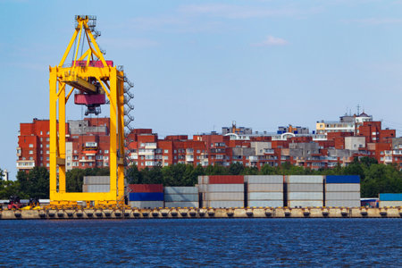 Empty sea cargo port. Cargo port on the background of urban buildings. A facility for loading...