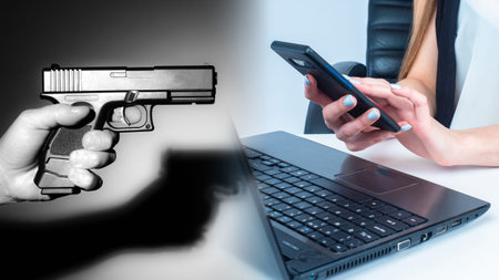 Threats by phone. Man with a phone next to a weapon. Concept - threatening calls. Telephone Terrorism. Concept - a man is looking for a killer. Received calls with threats. Pistol. Call to the killerの写真素材