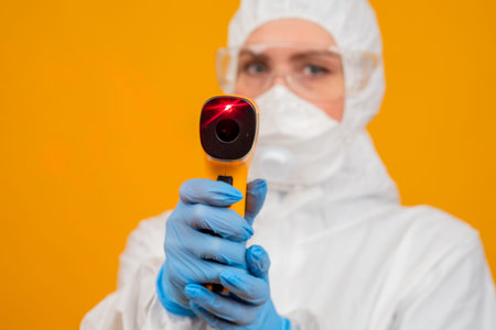 Epidemiology. The epidemiologist aimed the thermal imager at the camera. Lab technician looking at...