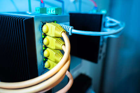 The colored wires are connected to the power supply. Network equipment. Computer networks. Electrical or network equipment. A fragment of telecommunications equipment. Telecommunications systems.の写真素材