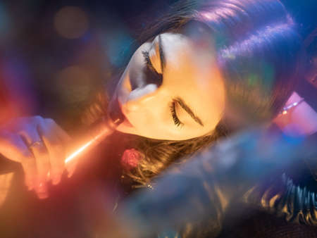 Vaper girl face top view. A woman smokes a vape. Student with a vape device. Women with an electronic cigarette. Concept - transient smoking electronic cigarettes. Buying vape devicesの写真素材