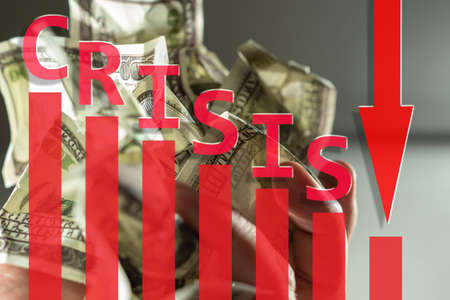 The crisis. Wash money close up. Drop chart and down arrow. Concept - recession in economy. The fall in income. The fall in purchasing power. World financial crisis. State bankruptcy.の写真素材