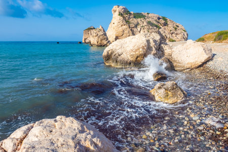 Cyprus. Rock Aphrodite. Splashing waves on the background of Aphrodite. Aphrodite's stones on the background of blue sky. The tide. Cyprus coast on a summer day. Travels in the Republic of Cyprusの写真素材