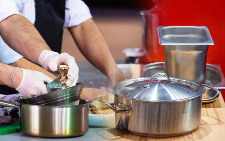 Chefs in the restaurant open oysters. Cooking oysters in a restaurant. Delicatessen. Concept - haute...