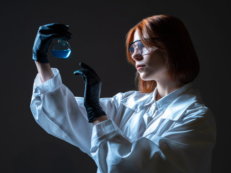 Woman laboratory technician. Young woman Laboratory assistant with a test tube in her hands....