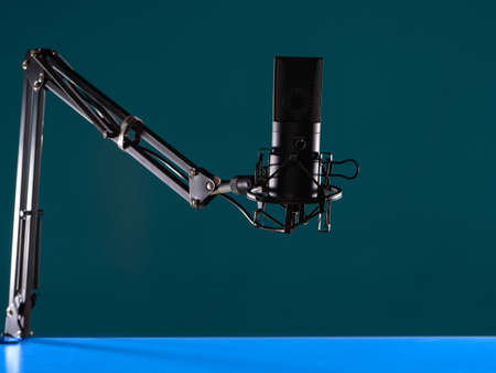 Studio microphone as a symbol of audio podcasts. Microphone for conducting audio podcasts. Studio microphone close-up. Concept - professional equipment for podcasting. Radio host deviceの写真素材
