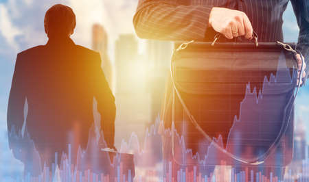 Asset management. A businessman with a portfolio on the background of charts. Data for business. Analysis of economic information. Planning the development of the company. Business plan.の写真素材