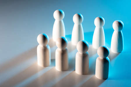 Man and woman equality concept. Gender equality of people. Gender equality in careers. White figurines of a man and women on the table. Men and women are facing each other.の写真素材