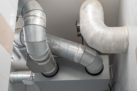 Pipes from ventilation systems or refrigeration equipment. Metal pipes under ceiling. Concept -...
