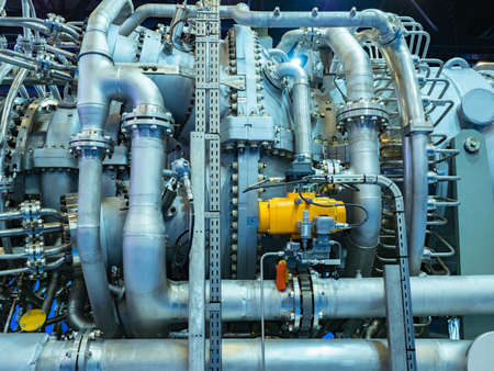 Installation with many small pipes in a chemical plant. Compressor at a chemical plant. A close-up of an industrial rig. Chrome plated compressor for the chemical industry. Technological production.の写真素材