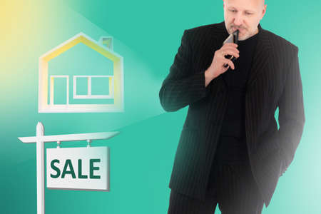 A man is considering buying a house. Purchase of real estate. Mortgage lending. Buying a home. Business in the real estate market. Buying a house on credit.の写真素材