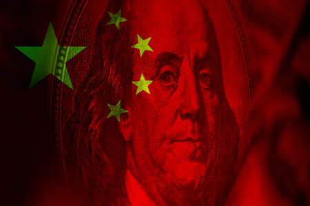 Franklin portrait with dollar. Franklin on the background of the flag China. Concept - influence of PRC on the global economy. Influence China on the dollar. Economy of the People's Republic of Chinaの写真素材