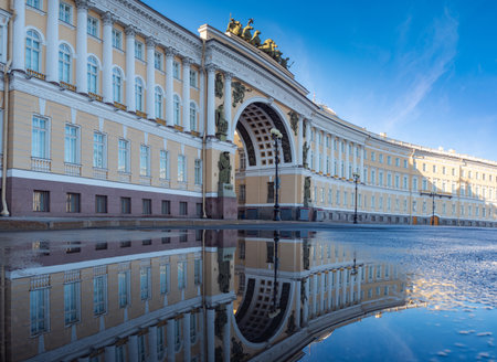 Palace Square in Saint Petersburg. Russia on background of blue sky. General headquarters building on a summer day. Headquarters building is reflected in water. Tour of Petersburg. Travel in Russia.のeditorial素材