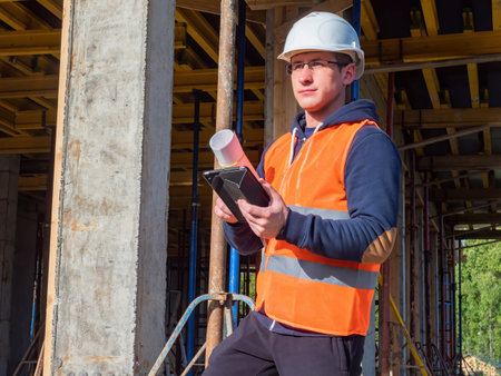 Builder construction portrait. Builder worker on background of building under construction. Man...