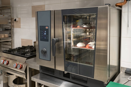 Combi steamer in confectionery shop. Some confectionery is being prepared inside combi steamer....