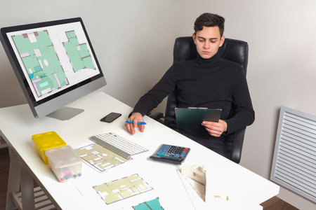 Architect at work. Guy is architect in his office. He works with architectural drawings....