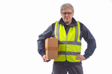 A courier with a package under his arm. A man holds a cardboard box and smiles at the camera. A...