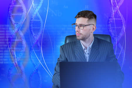 Genetic research. A scientist at a laptop against the background of DNA spirals. The doctor analyzes the genetic tests. Gene transfer and gene therapy. Gene manipulation.の写真素材
