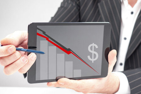 Negative financial outlook. Analyst shows a bad financial forecast. He shows a falling graph on...