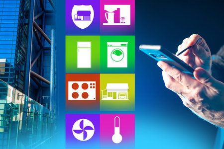 Control engineering services through a smartphone. Concept - modern housing with remote control....