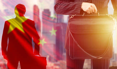 Entering the Chinese market. Business in China. Business relations with PRC. Businessman on the background of the Chinese flag. People in business suits and carrying briefcases. Business expansion.の写真素材