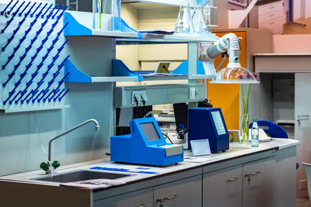 Chemical or medic laboratory. Extractor fan is above the desktop. Laboratory equipment. Empty medical laboratory with furniture. Sale of laboratory equipment. Medical laboratory equipment.の写真素材