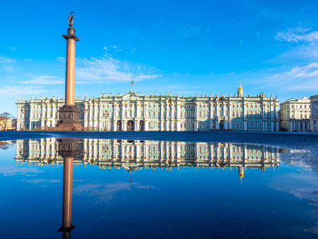 Saint Petersburg Museums. Panorama of Russia on a blue sky background. Winter Palace in sunny weather. It is reflected in water. Travels across Saint Petersburg. Museums of Russian cities.のeditorial素材