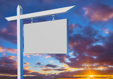 Real estate sign on sky background. White real estate sign next to sunset. Place for inscription on real estate sign. Signboard 3d for inscription on sale of house. Place to advertise sale of houseの写真素材